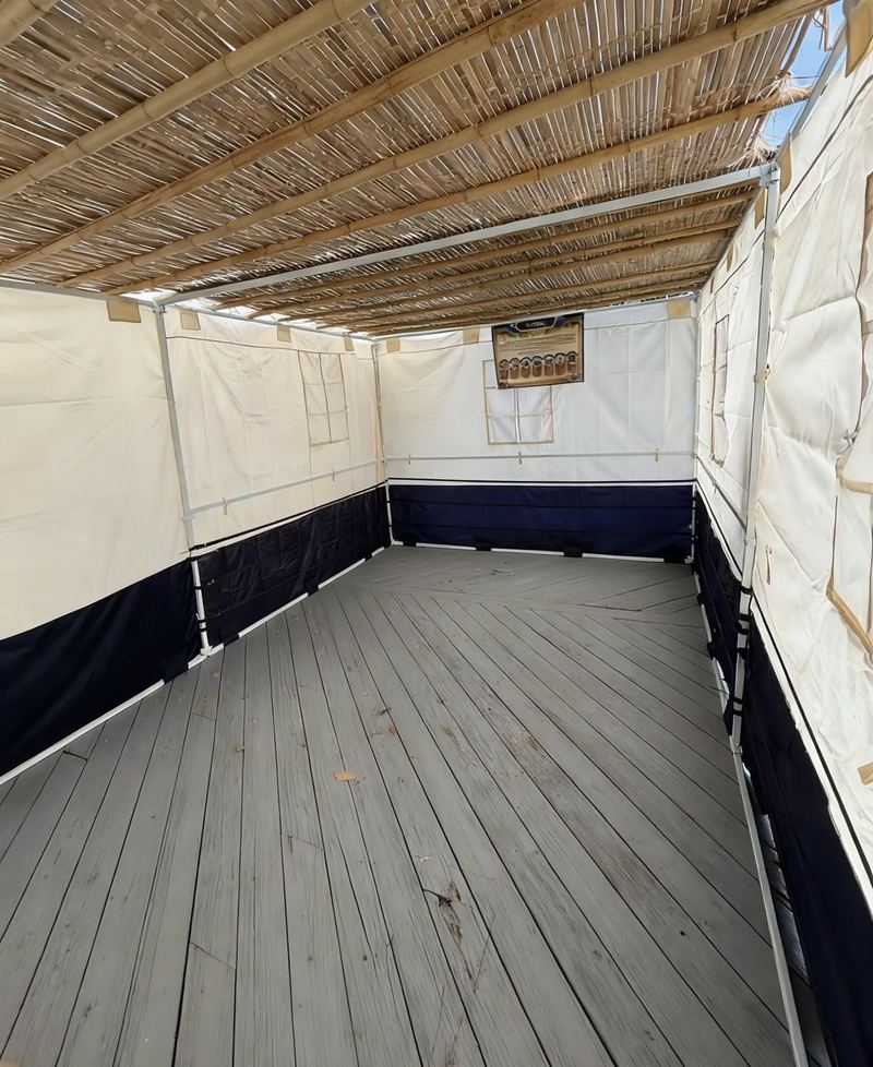 A canvas sukkah set up by Premium Sukka Builders